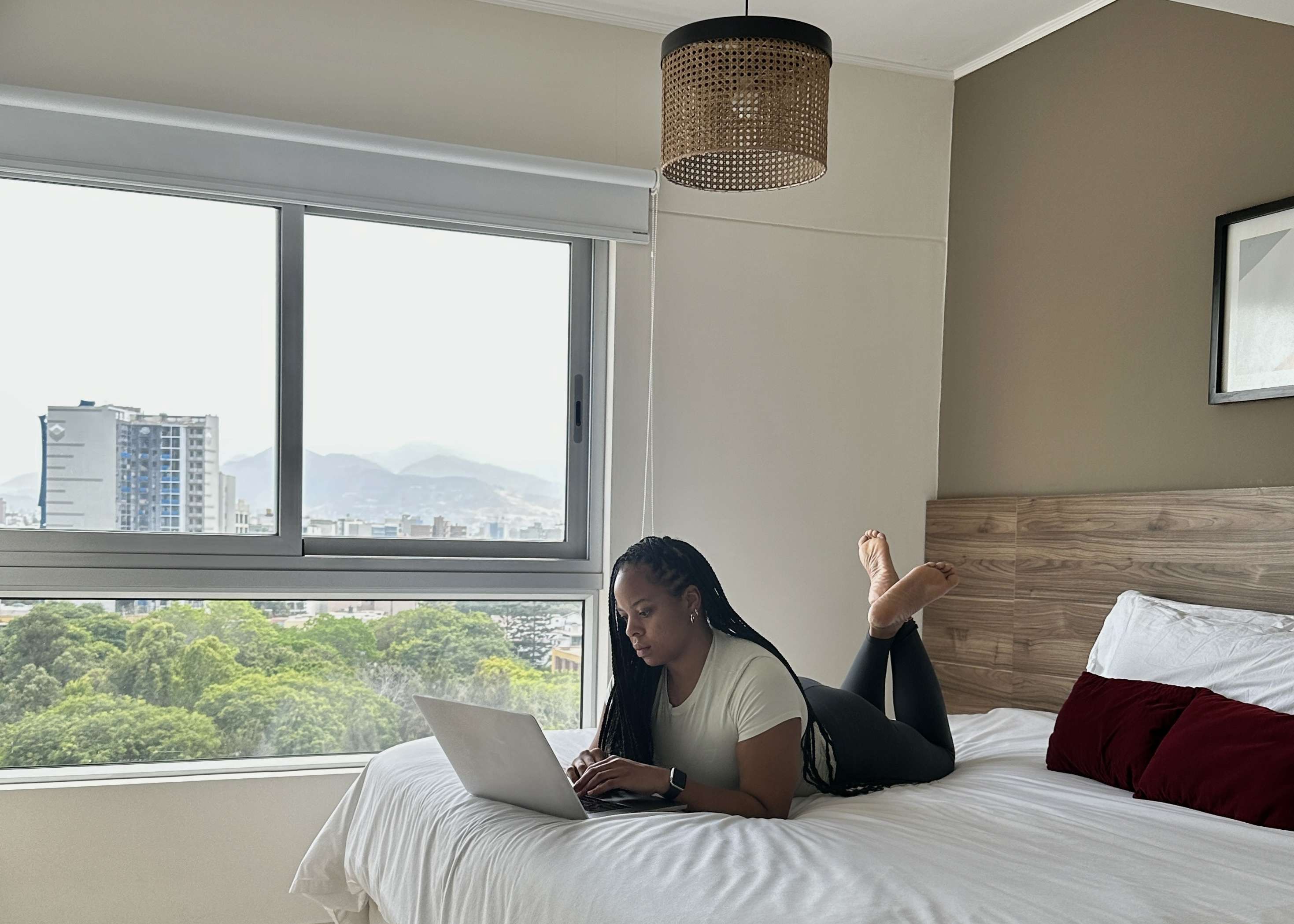 Dru Sitting on the bed in an airbnb in Miraflores lima, Peru