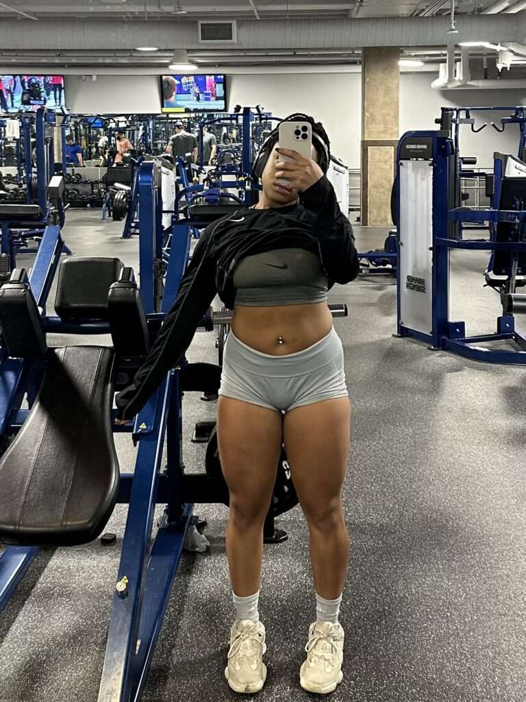 dru taking a mirror picture at the gym