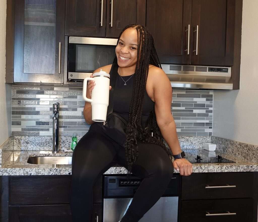 dru sitting on countertop holding water bottle