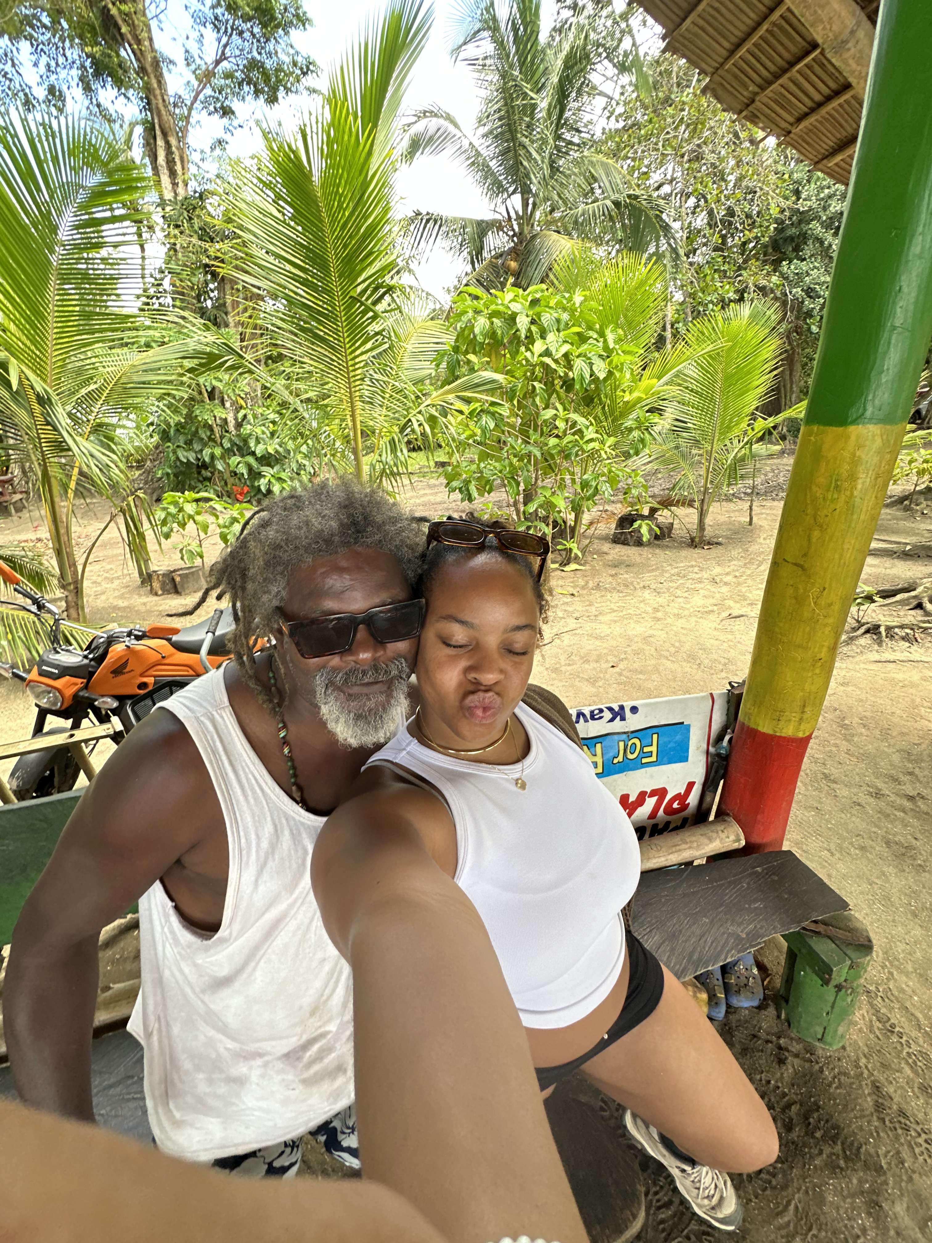 Traveler with a local Rasta man on the beach in Punta Uva, Puerto Viejo, Costa Rica